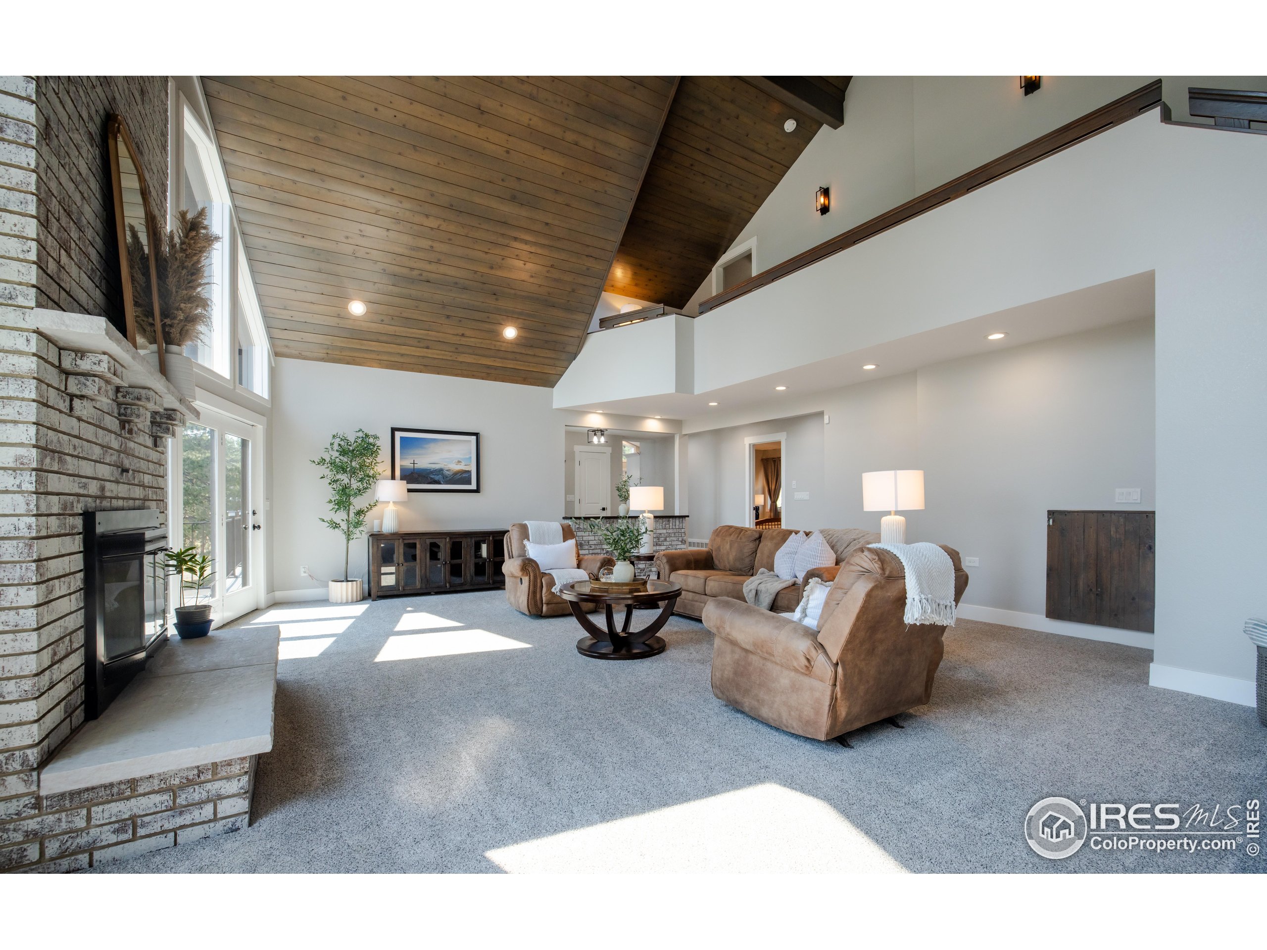 8987 Village Pines Circle Franktown, CO 80116 - Photo 3 of 31 a living room with fireplace furniture and a flat screen tv