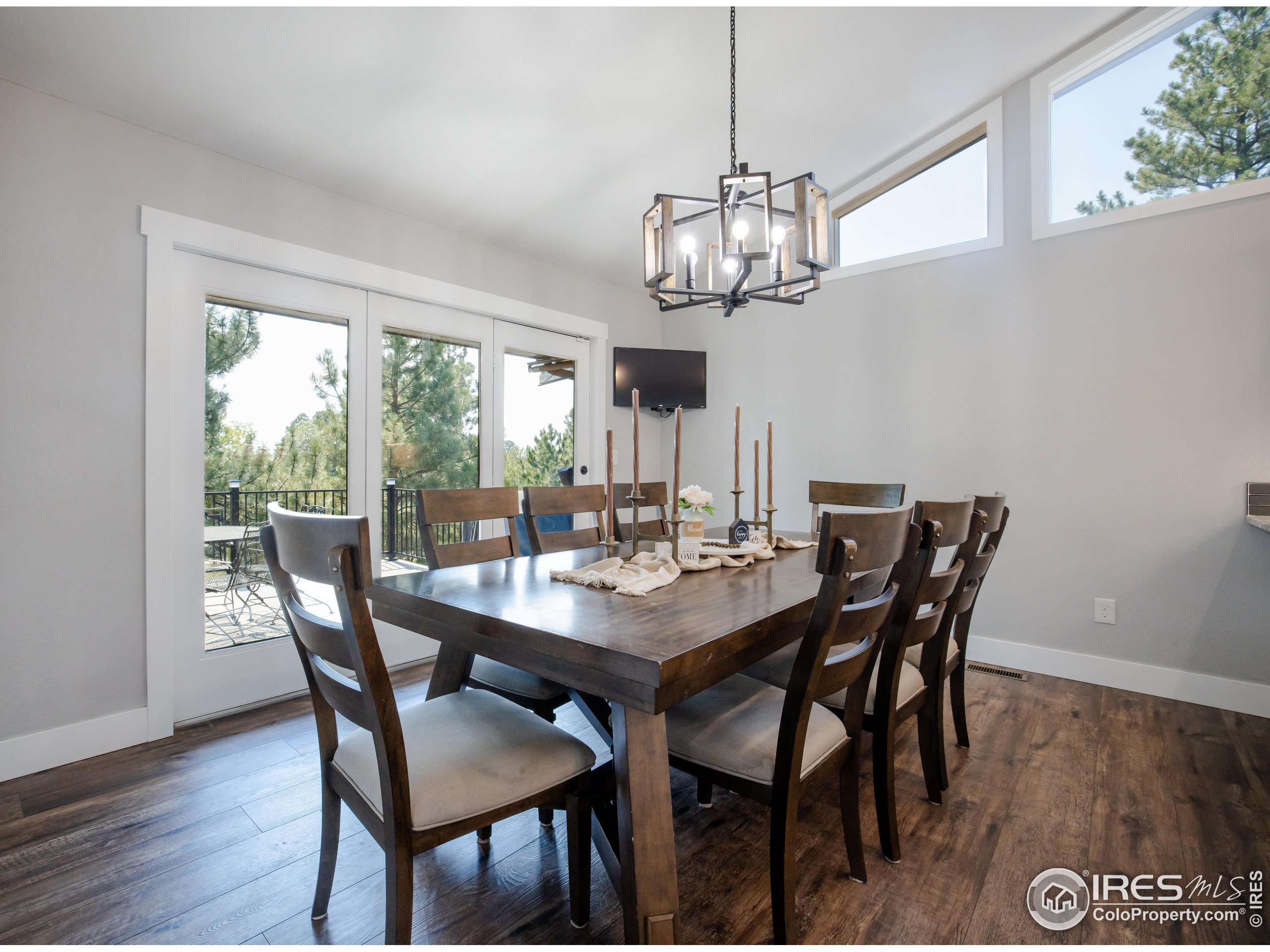 8987 Village Pines Circle Franktown, CO 80116 - Photo 6 of 31 a view of a dining room with furniture window and wooden floor