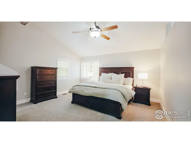 a bedroom with a bed and a ceiling fan
