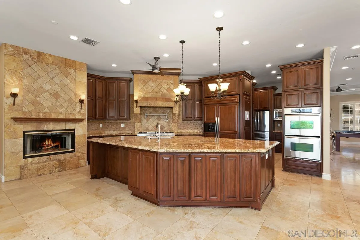 4103 Fallsbrae Road Fallbrook, CA 92028 - Photo 15 of 48 a large kitchen with a large kitchen island a sink a stove and a refrigerator