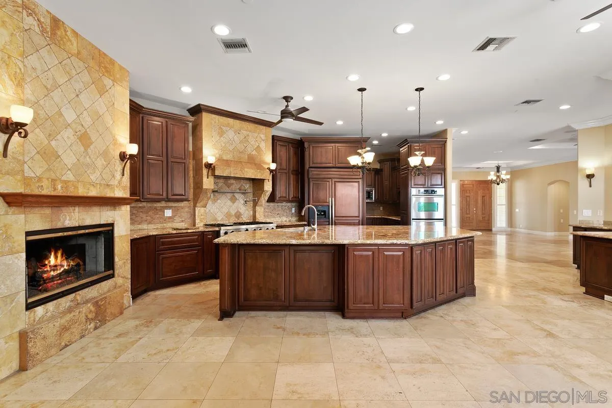 4103 Fallsbrae Road Fallbrook, CA 92028 - Photo 16 of 48 a large kitchen with stainless steel appliances granite countertop a stove a sink and a refrigerator