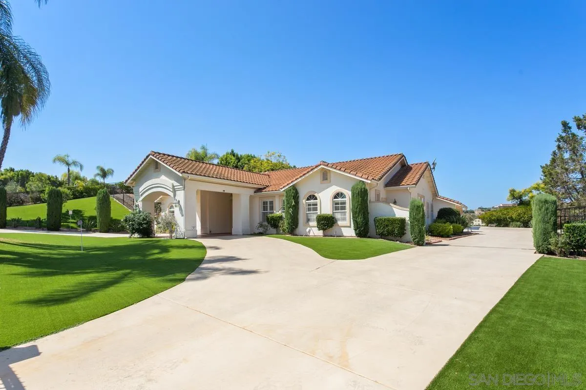4103 Fallsbrae Road Fallbrook, CA 92028 - Photo 6 of 48 a front view of a house with a yard and garage