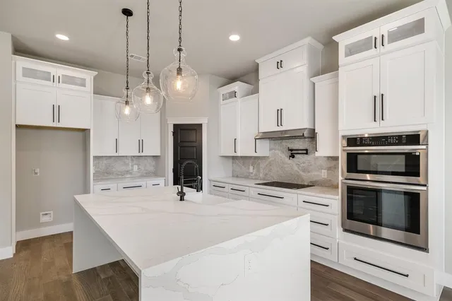 a kitchen with stainless steel appliances a stove a sink and a refrigerator