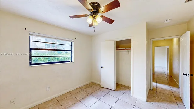 a view of room with a ceiling fan and window