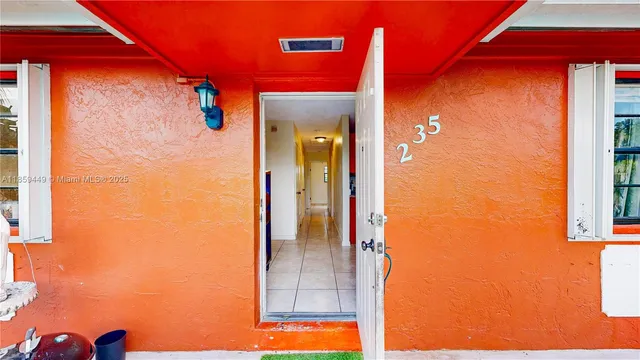 a view of a balcony with a door and a yard