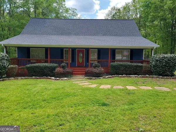a front view of a house with a yard and porch