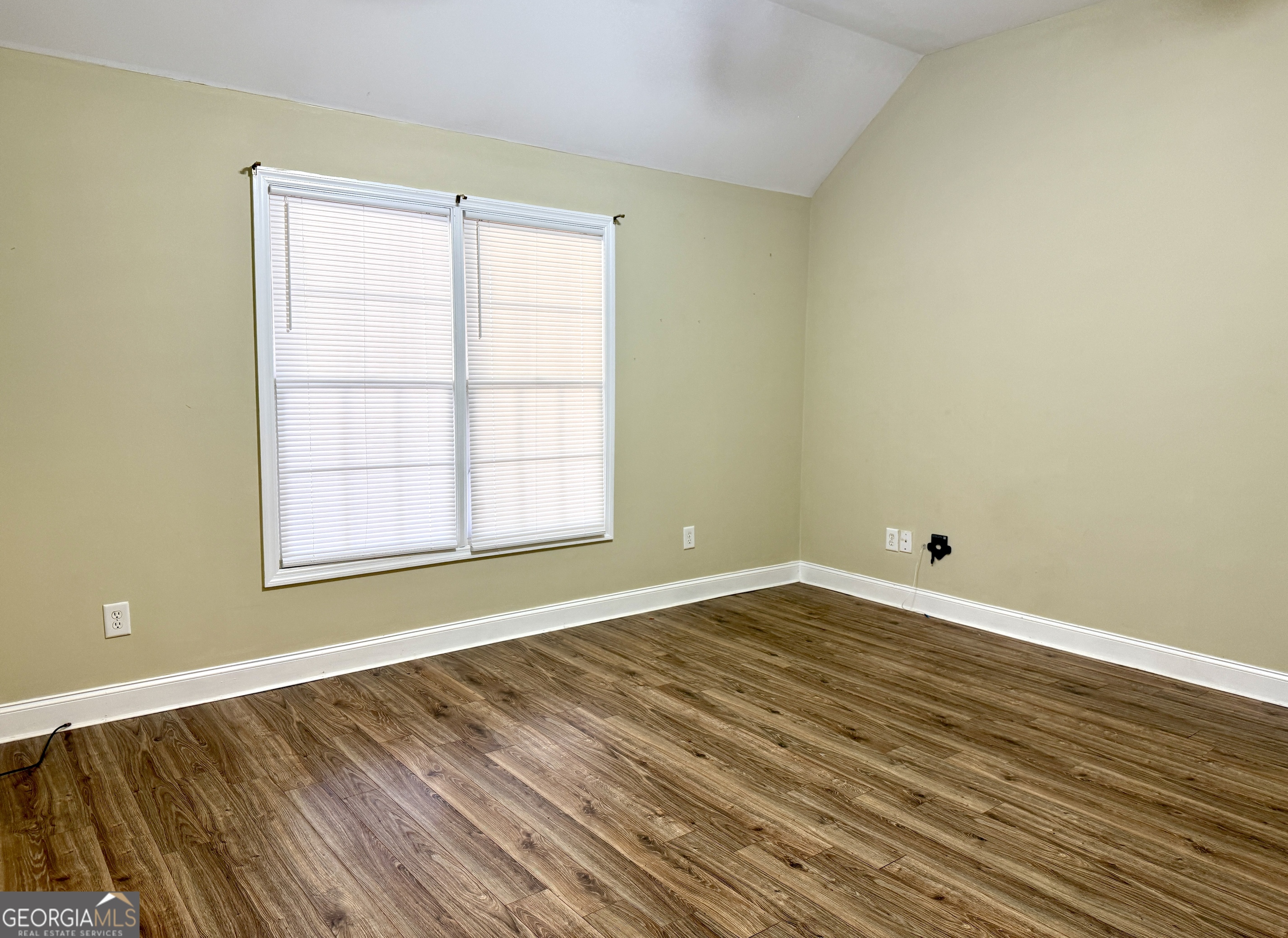 4770 Colham Ferry Road Watkinsville, GA 30677 - Photo 11 of 20 a view of an empty room with wooden floor and a window