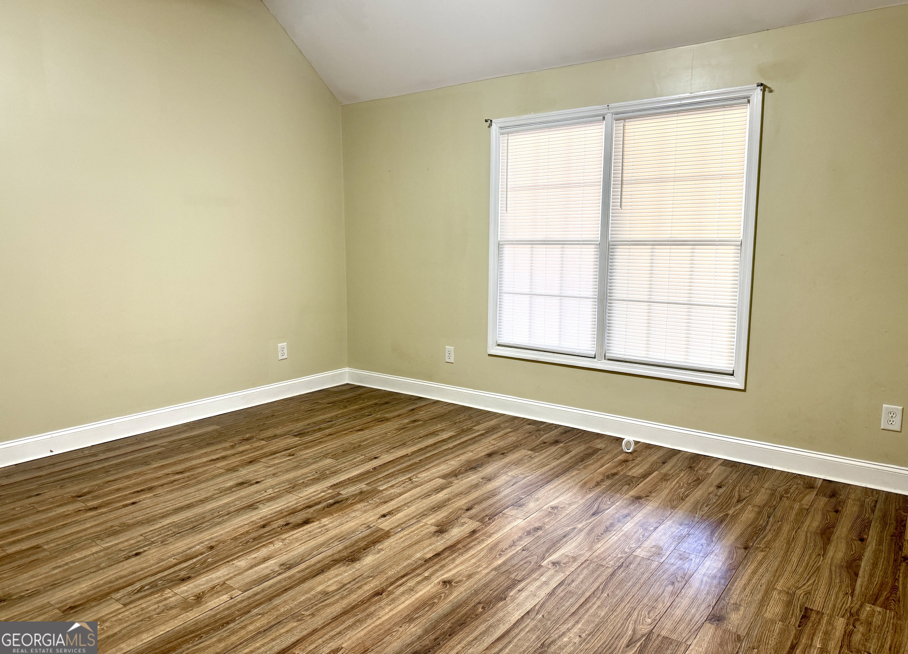 4770 Colham Ferry Road Watkinsville, GA 30677 - Photo 12 of 20 a view of an empty room with wooden floor and a window
