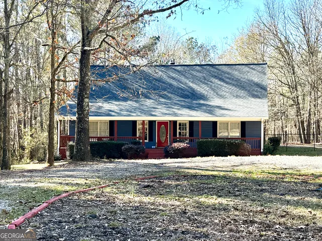a view of a house with a yard covered in snow