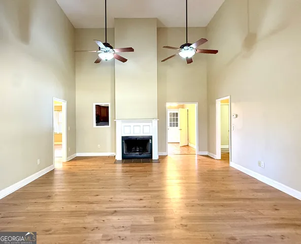 a kitchen with stainless steel appliances granite countertop a refrigerator a stove a sink and dishwasher with wooden floor