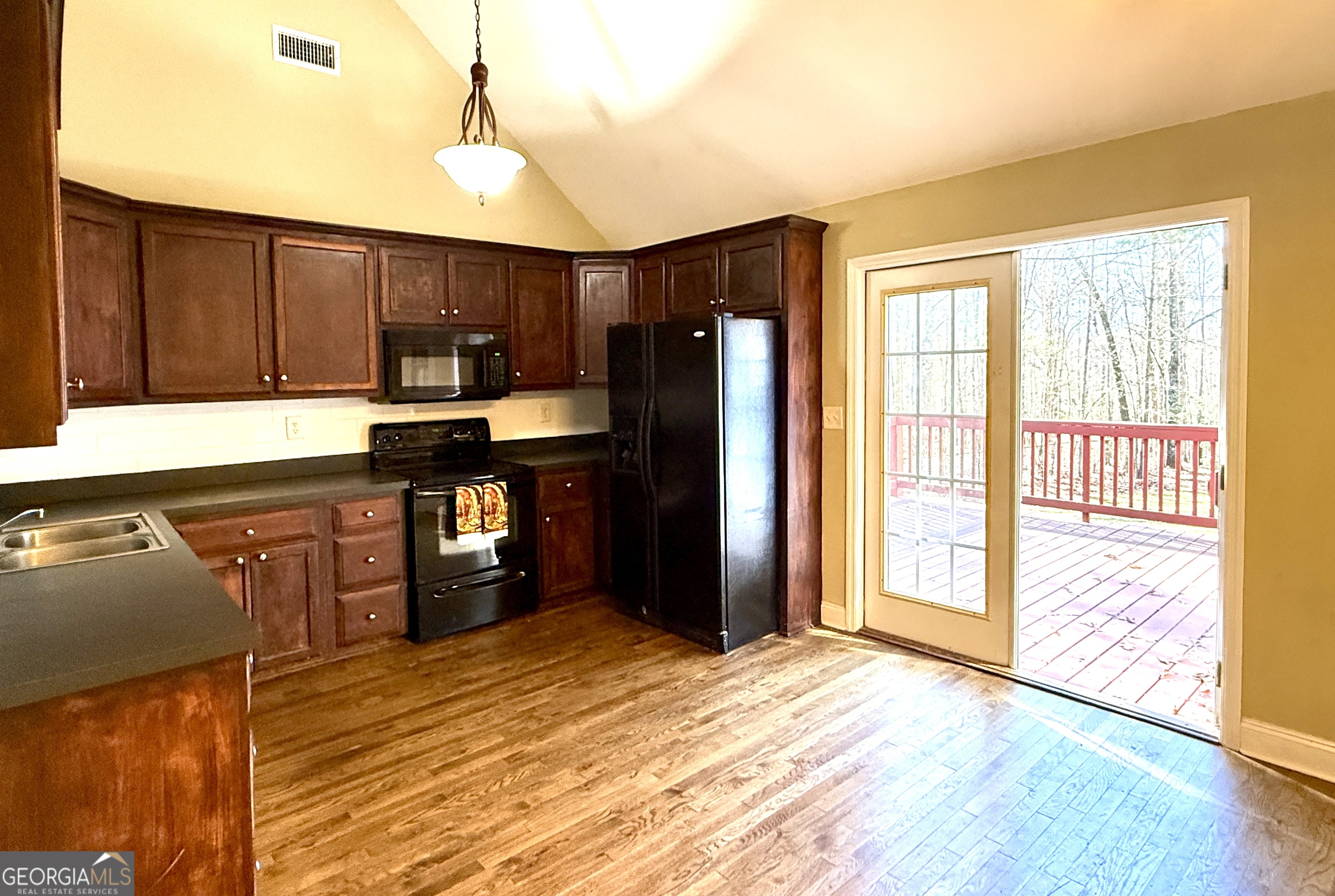 4770 Colham Ferry Road Watkinsville, GA 30677 - Photo 6 of 20 a kitchen with stainless steel appliances granite countertop a refrigerator a stove a sink and dishwasher with wooden floor
