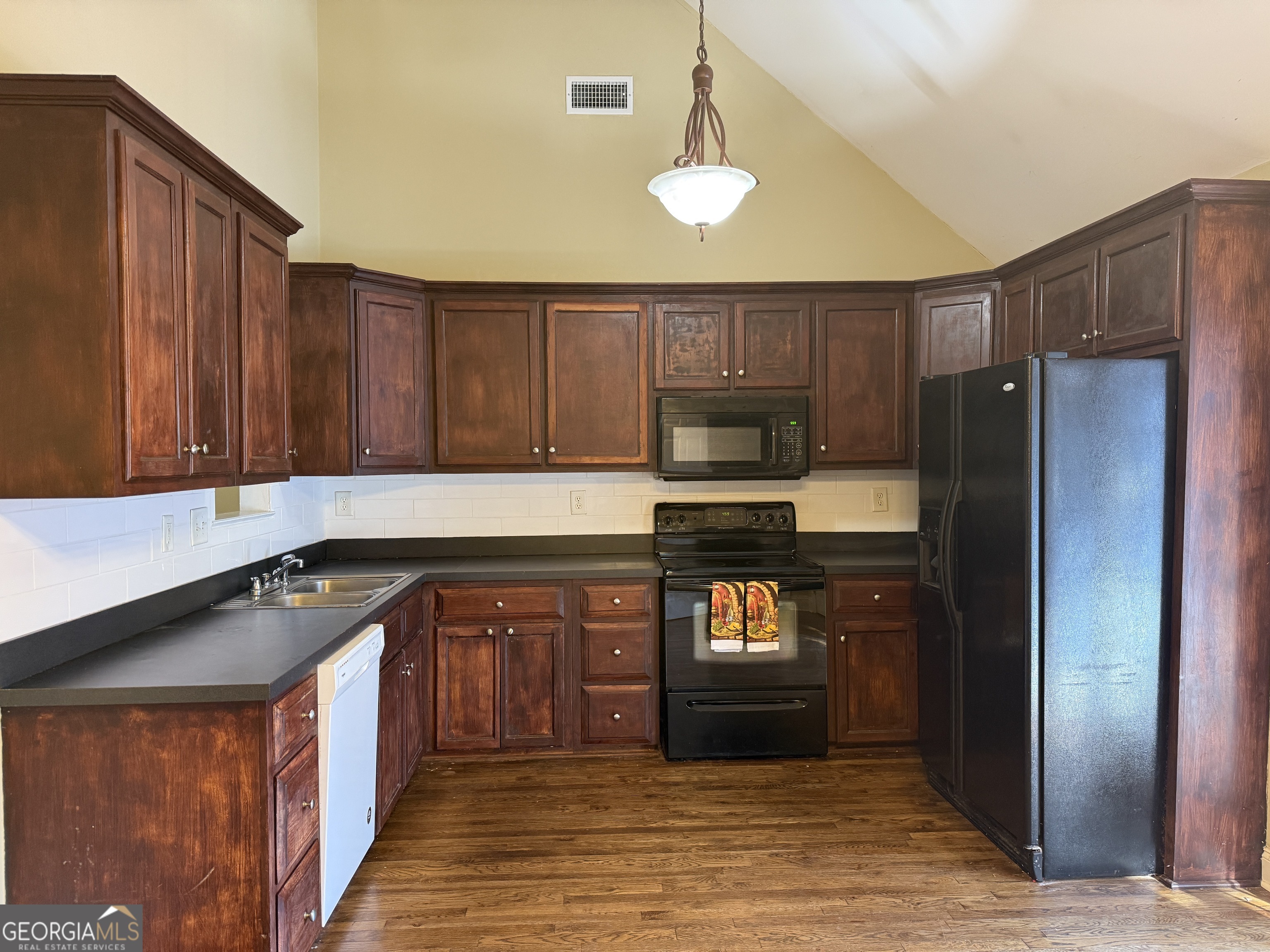 4770 Colham Ferry Road Watkinsville, GA 30677 - Photo 7 of 20 a kitchen with kitchen island granite countertop wooden cabinets a refrigerator and a sink