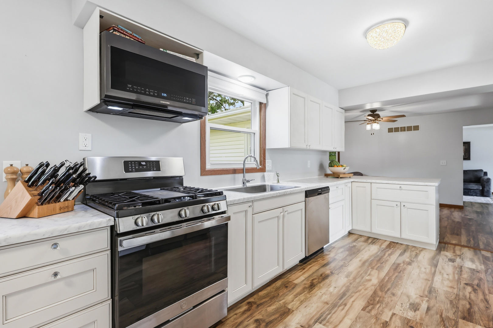 4314 Spring Street Davenport, IA 52807 - Photo 11 of 51 a kitchen with stainless steel appliances a stove a microwave and cabinets