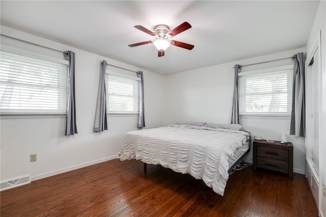6950 Red Lion 5 Points Road Springboro, OH 45066 - Photo 28 of 78 This cozy bedroom features elegant hardwood flooring and a functional ceiling fan for comfort.