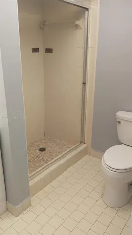 a white toilet sitting next to a bath tub