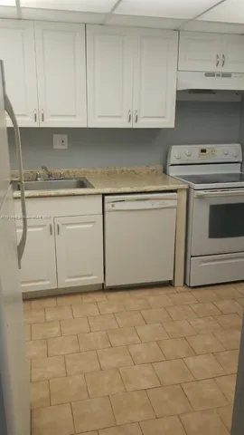 a kitchen with white cabinets