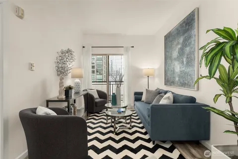 a living room with furniture and a potted plant