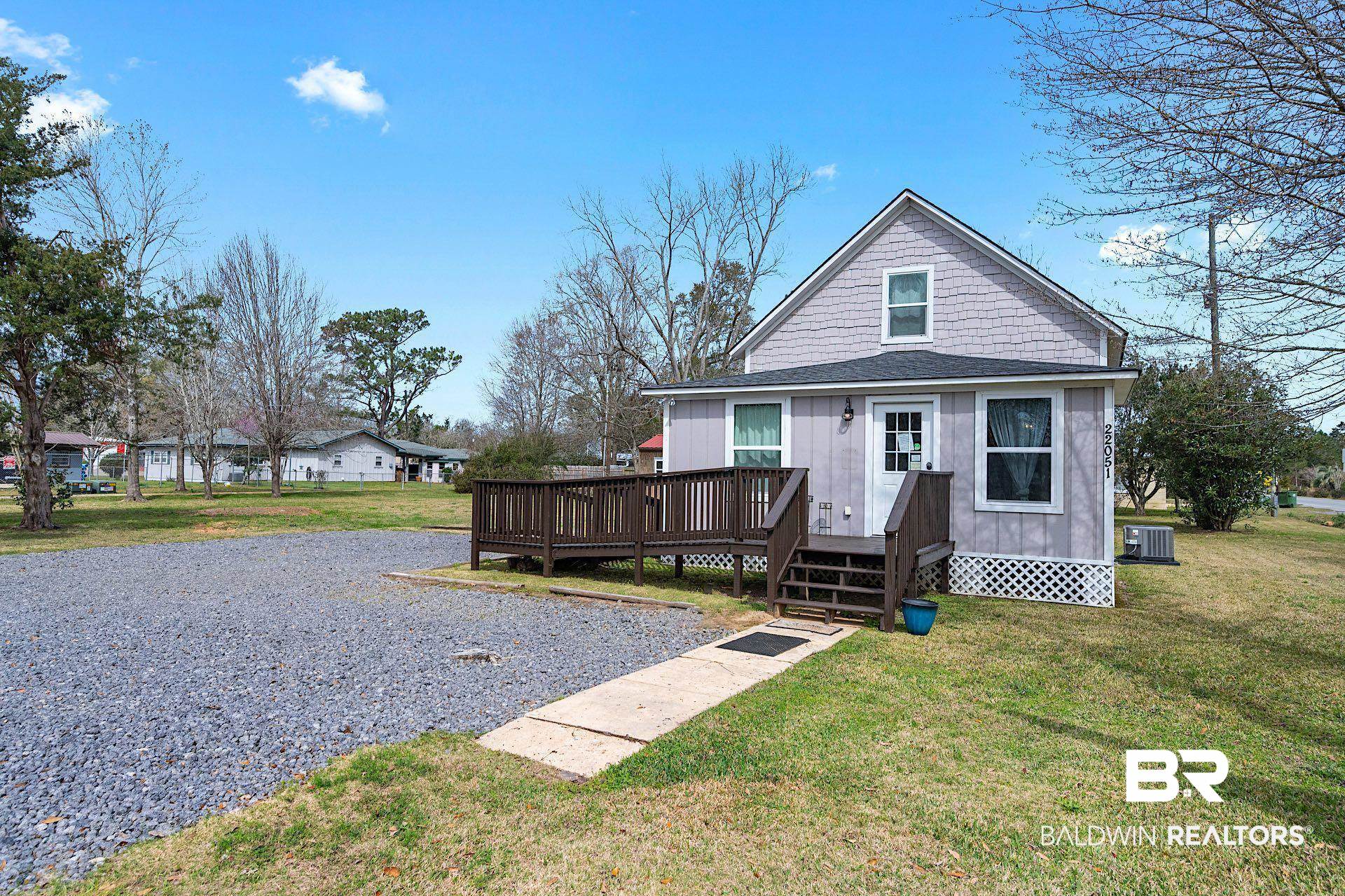 22051 Broad Street Silverhill, AL 36576 - Photo 2 of 28 View of front of property featuring a wooden deck, a front lawn, and central AC