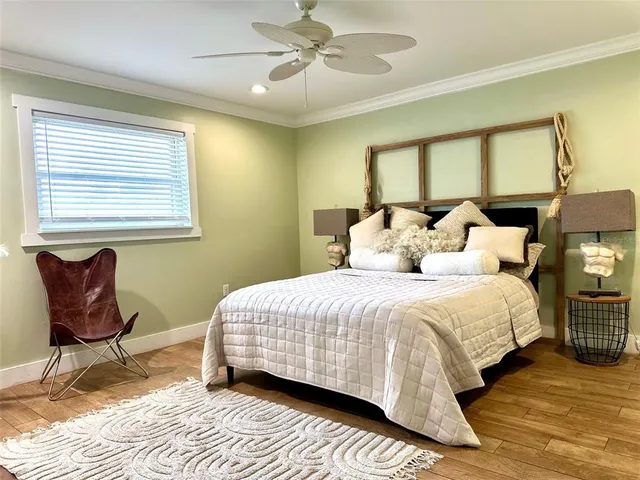 a bedroom with a bed and wooden floor