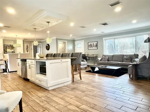 a living room with furniture and kitchen view