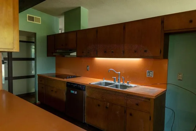 a kitchen with a sink and cabinets