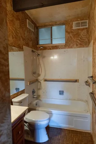 a bathroom with a toilet and a shower