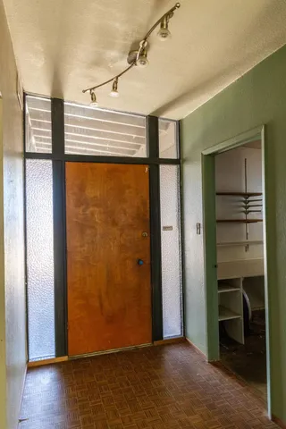 a view of a room with wooden floor