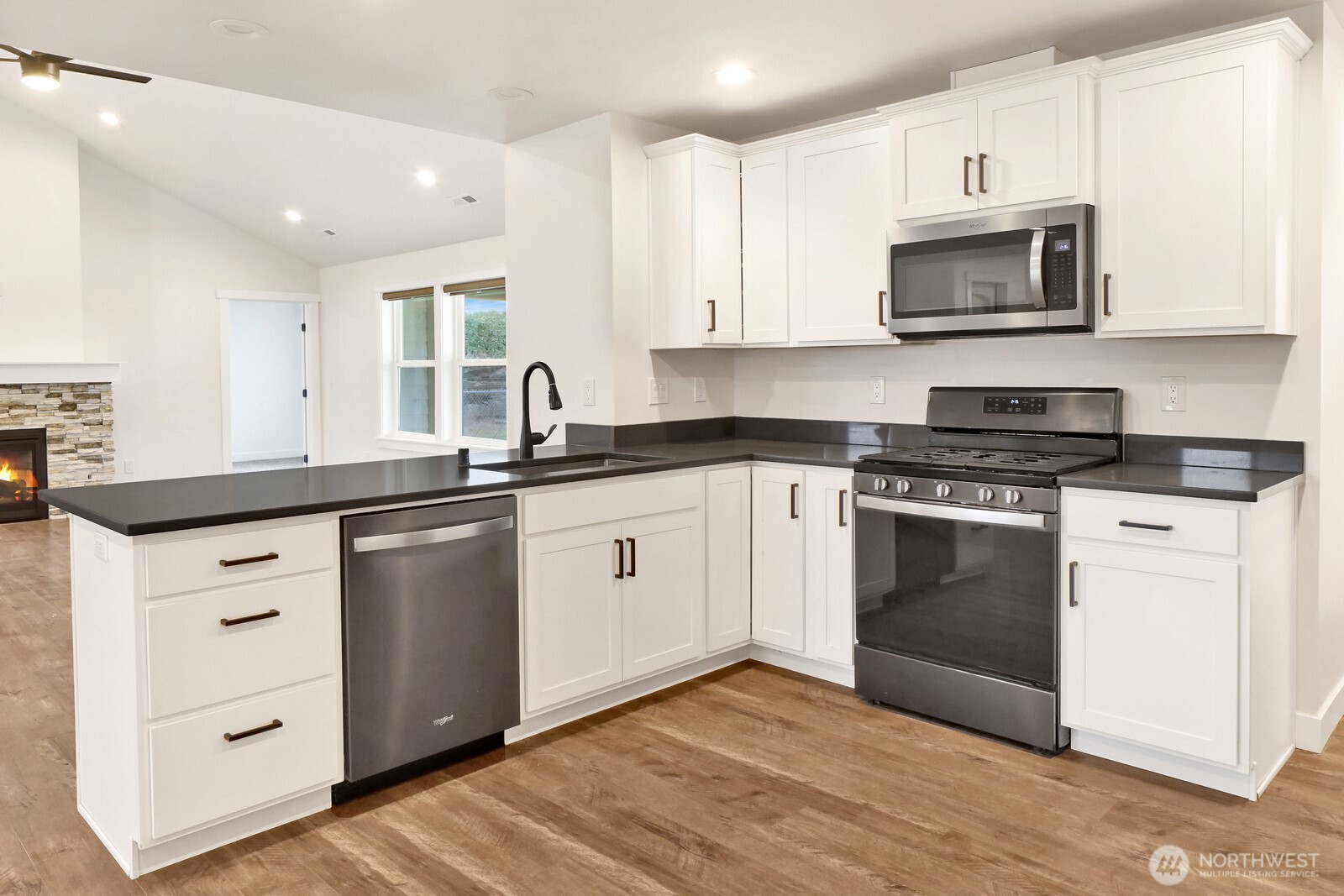 1302 Night Hawk Way Everson, WA 98247 - Photo 19 of 35 a kitchen with granite countertop white cabinets and stainless steel appliances