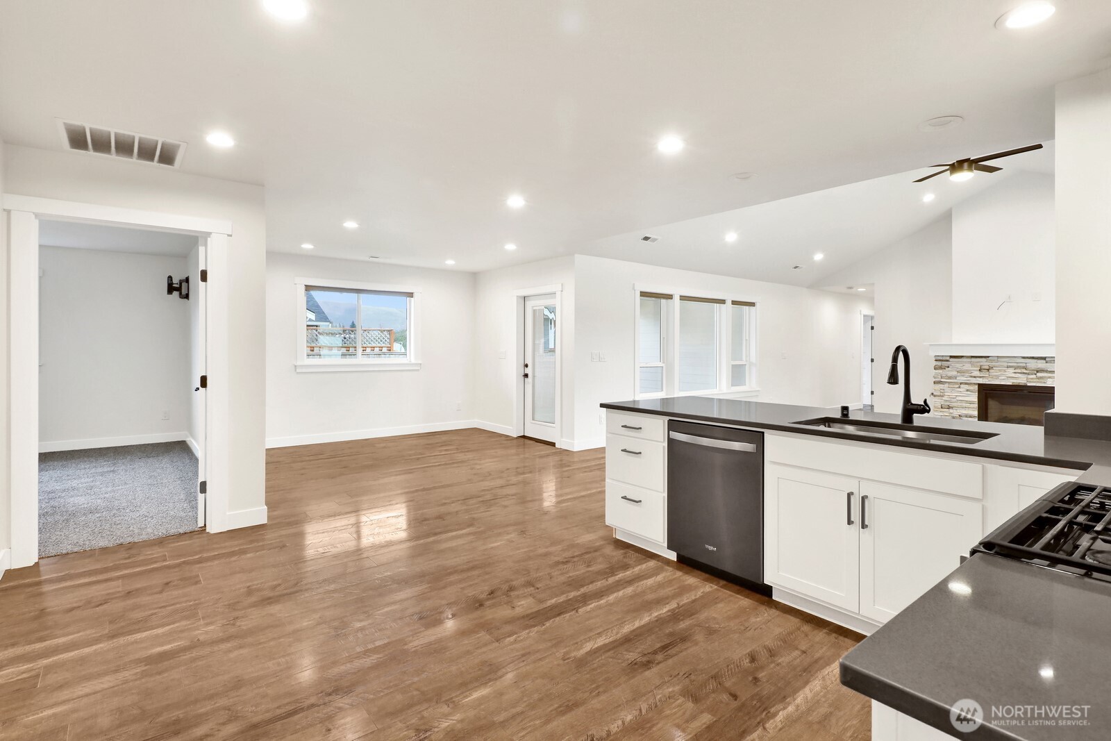 1302 Night Hawk Way Everson, WA 98247 - Photo 20 of 35 a large white kitchen with wooden floors and stainless steel appliances