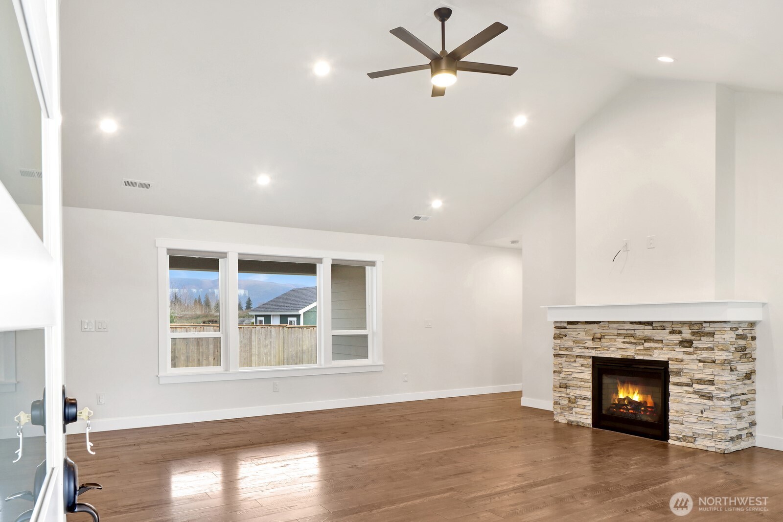 1302 Night Hawk Way Everson, WA 98247 - Photo 5 of 35 a view of an empty room with a fireplace and a window