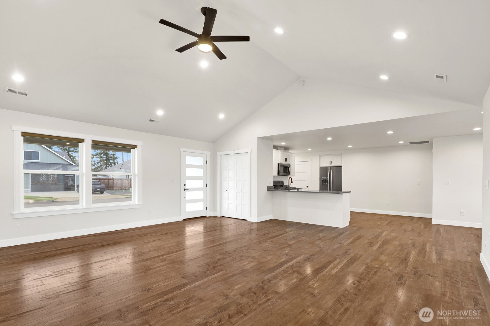 1302 Night Hawk Way Everson, WA 98247 - Photo 10 of 35 an empty room with wooden floor and windows
