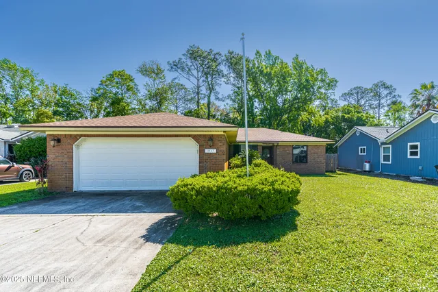 a living room with furniture and large windows