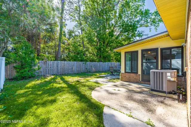 a view of a back yard with potted plants
