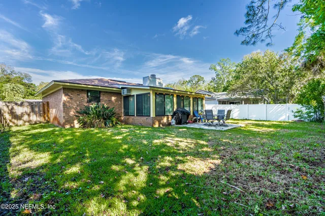 a view of a house with backyard and porch