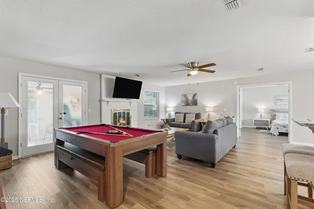 a living room with furniture a flat screen tv and a table