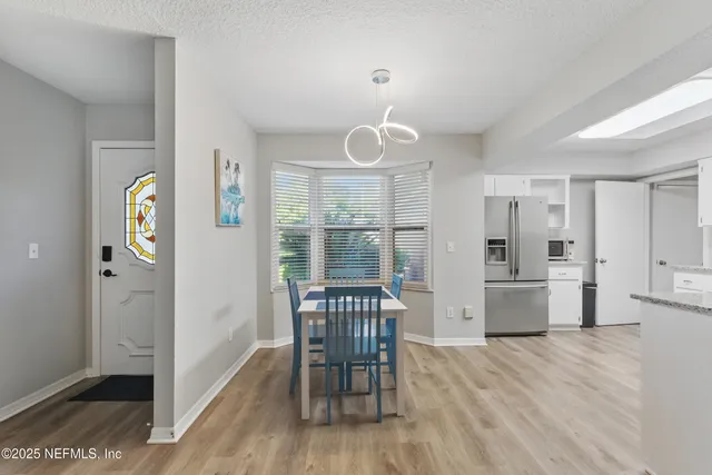 a view of kitchen with furniture and wooden floor