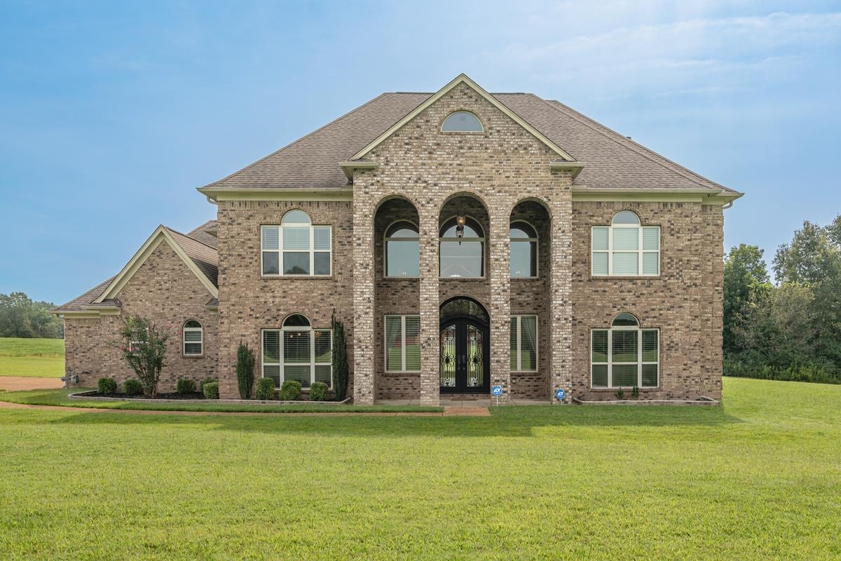8250 Deadfall Road Millington, TN 38053 - Photo 1 of 26 a front view of a house with a garden