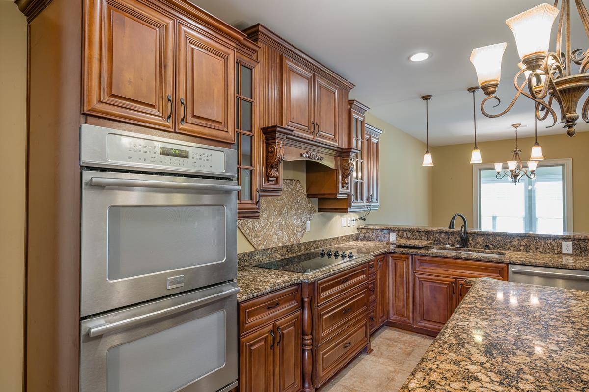 8250 Deadfall Road Millington, TN 38053 - Photo 13 of 26 a kitchen with granite countertop stainless steel appliances and wooden cabinets