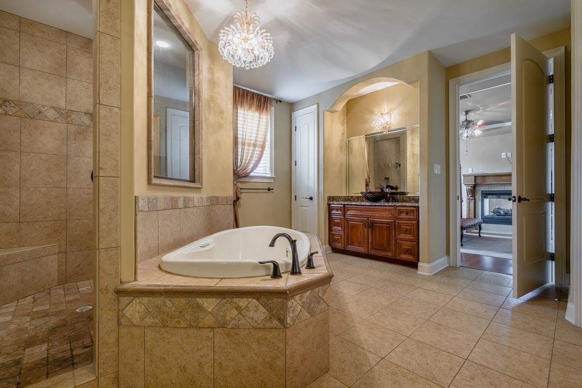 8250 Deadfall Road Millington, TN 38053 - Photo 18 of 26 a bathroom with a tub sink and mirror
