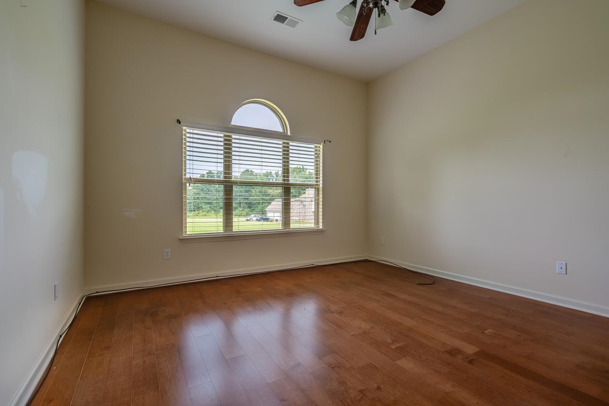 8250 Deadfall Road Millington, TN 38053 - Photo 22 of 26 an empty room with windows and chandelier fan