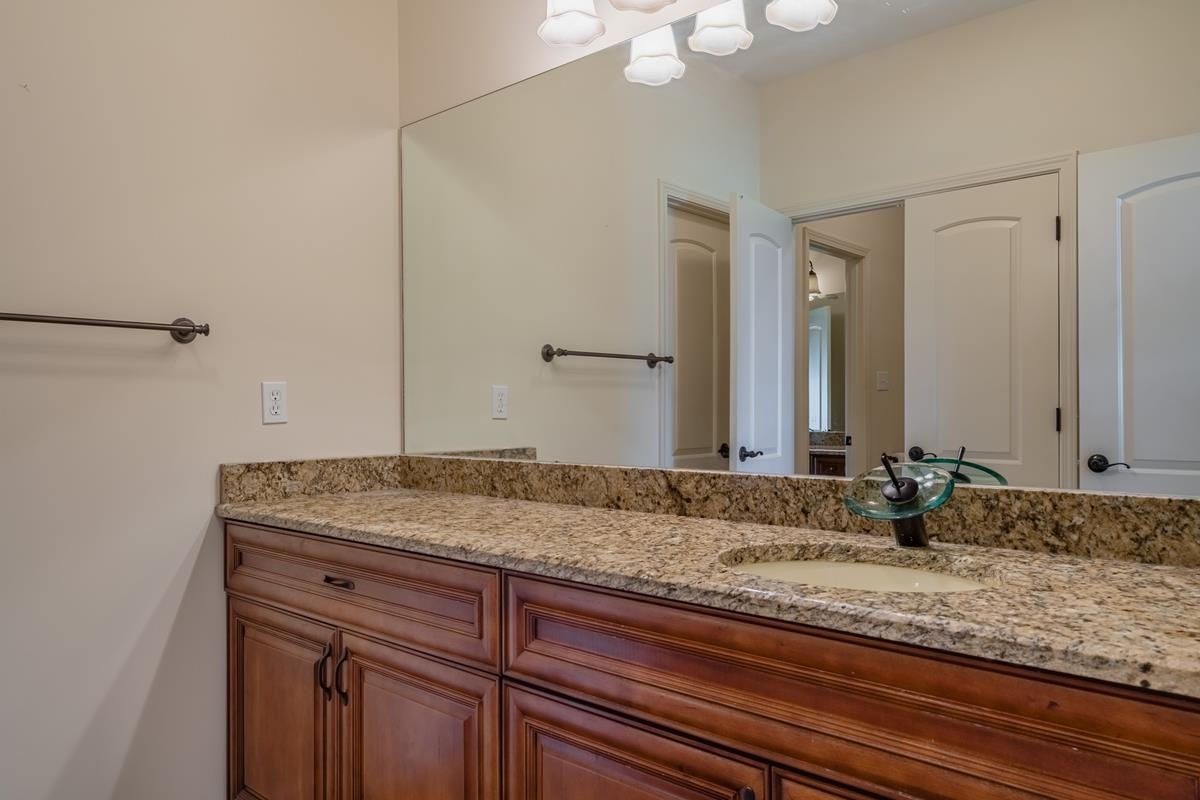8250 Deadfall Road Millington, TN 38053 - Photo 23 of 26 a bathroom with a granite countertop sink and a mirror