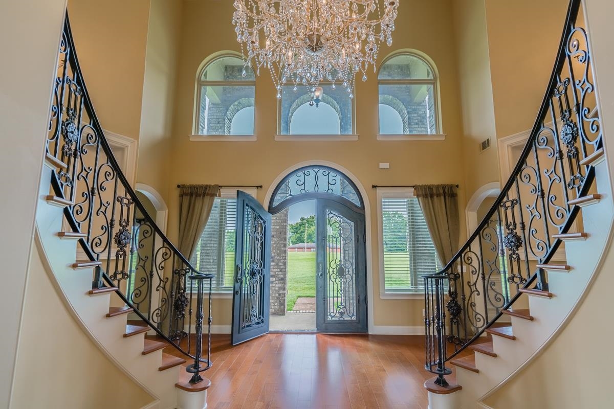 8250 Deadfall Road Millington, TN 38053 - Photo 4 of 26 a view of staircase with three windows and a chandelier