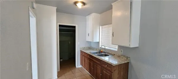 a kitchen with a stove top oven and sink