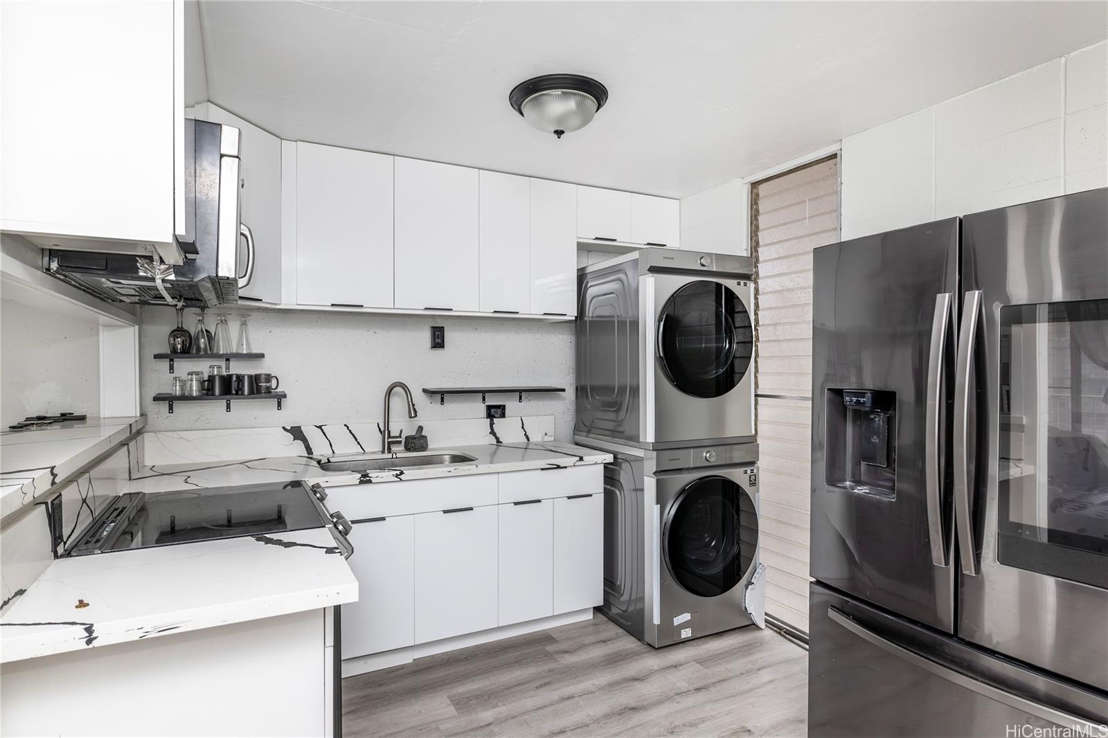 a utility room with sink dryer and washer