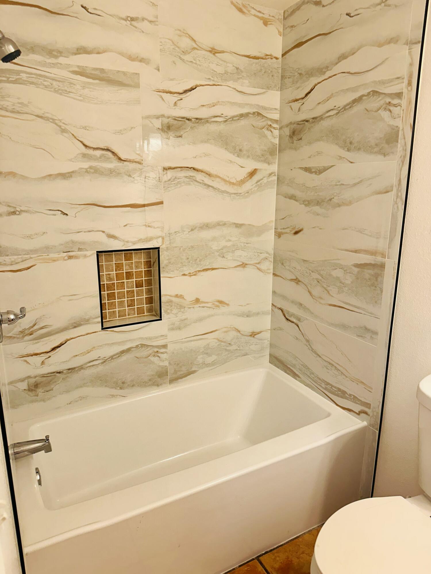30880 Farr Road Visalia, CA 93291 - Photo 13 of 27 a bathroom with a toilet and a bathtub