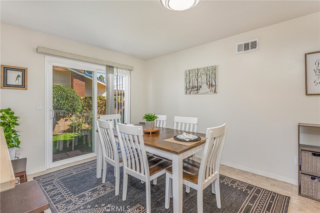 8651 Holly Street Rancho Cucamonga, CA 91701 - Photo 12 of 29 a view of a dining room with furniture window and wooden floor