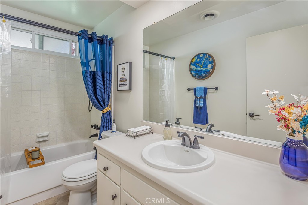 8651 Holly Street Rancho Cucamonga, CA 91701 - Photo 13 of 29 a bathroom with a sink a toilet and a mirror