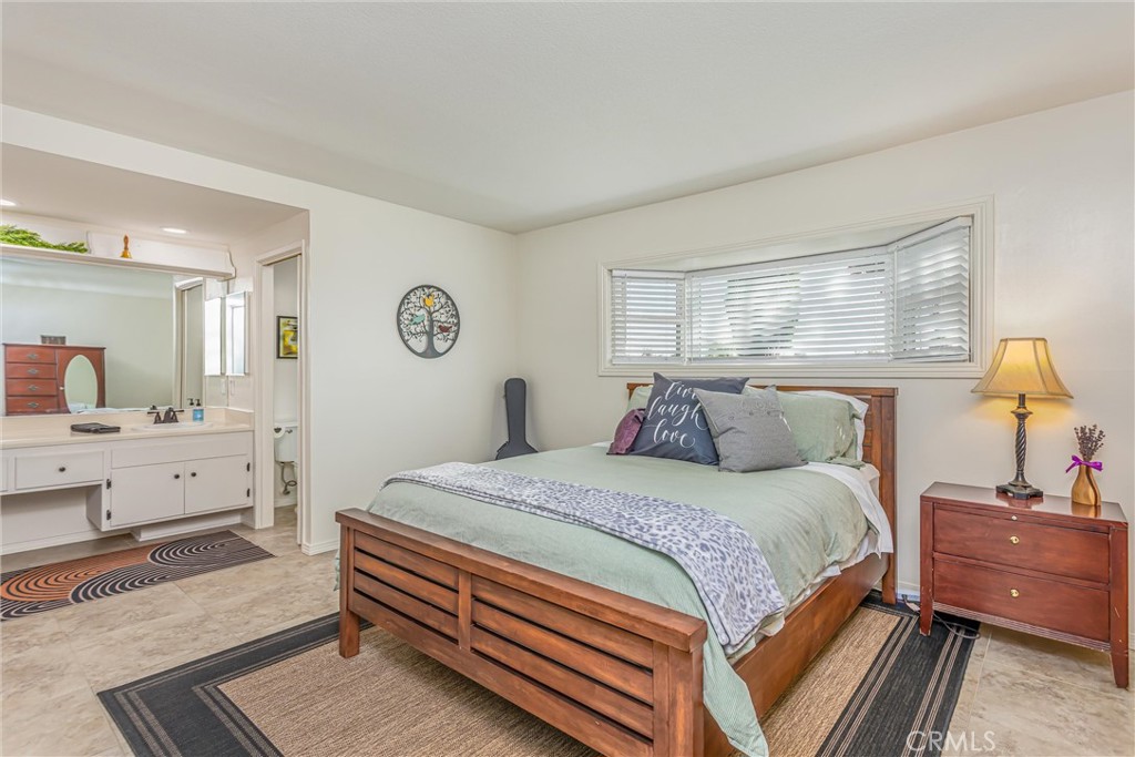 8651 Holly Street Rancho Cucamonga, CA 91701 - Photo 14 of 29 a bedroom with a bed and wooden floor