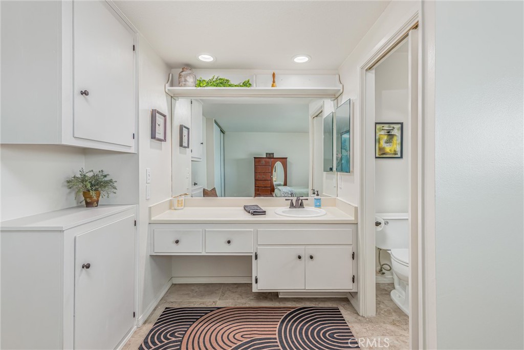 8651 Holly Street Rancho Cucamonga, CA 91701 - Photo 16 of 29 a spacious bathroom with a sink a mirror and vanity