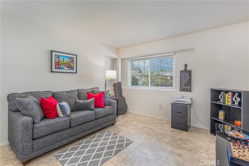 8651 Holly Street Rancho Cucamonga, CA 91701 - Photo 17 of 29 a living room with furniture and a window